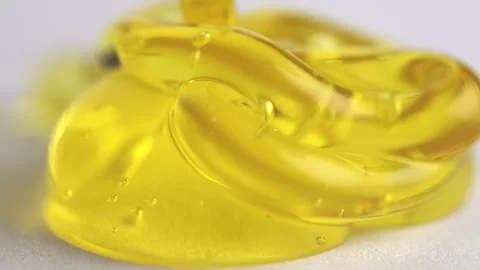 Yellow transparent peeling gel with bubbles pouring, macro texture of orang.. Stock Footage 261535534