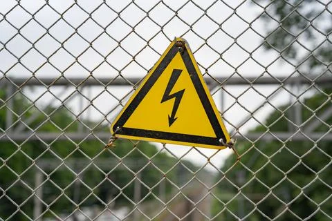 Yellow triangle with black lightning Stock Photos