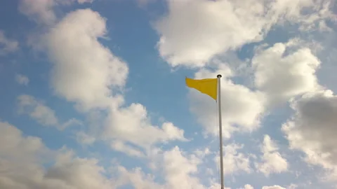Yellow triangle flag indicating medium hazard, at a beach in France Stock-Footage 135405871