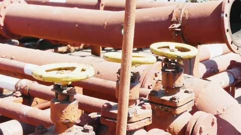 Yellow valve in thin red rusty pipes in sea ship. Machinery and equipment of  Stock-Footage 114625573