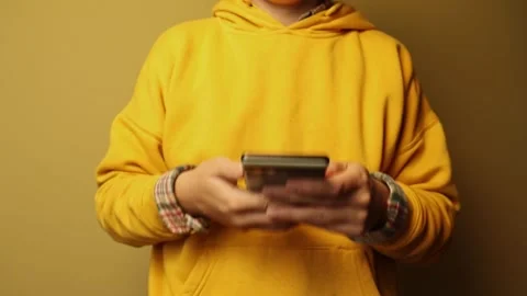 Yellow Vibe. Shaking Hands with a Hanging Android Phone. a person hands sha.. Stock Footage 319020800