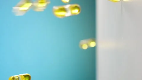 Yellow Vitamin Capsules Falling Down Видео 269768119