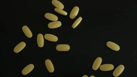Yellow Vitamin Tablets Pouring From Bottle Vidéo 340340988