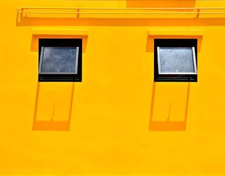 Yellow wall with 2 windows Stock Photos