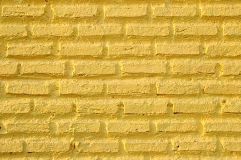 Yellow wall from bricks for background. Stock Photos