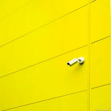 Yellow Wall with Security Camera Stock Photos