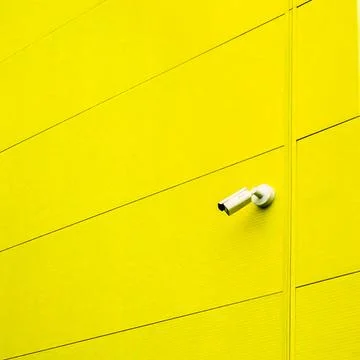 Yellow Wall with Security Camera Stock Photos