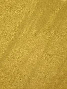 Yellow Wall Surface with Rough Texture Stock Photos