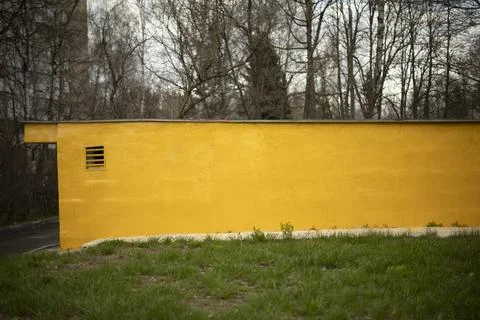 Yellow wall of technical structure. Architecture of non-residential building. Stock Photos