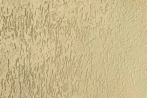 Yellow wall texture, building facade close up Stock Photos