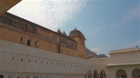 Yellow walls and chhatris of Amer Fort at Jaleb Chowk courtyard Jaipur India Stockbeeldmateriaal 345005176