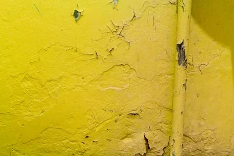 Yellow warm heating on the background of peeling paint on the wall Stockfoto's