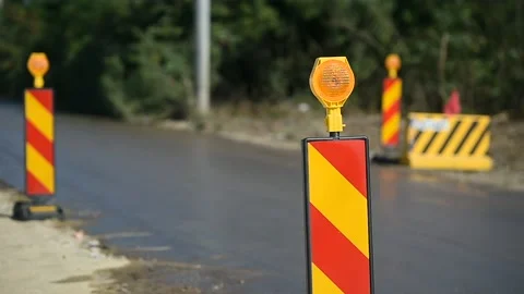 Yellow warning lights in a hazard zone during construction road works 스톡 동영상 137644747