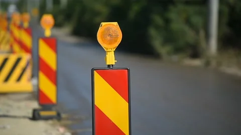 Yellow warning lights in a hazard zone during construction road works Stock Footage 137644752