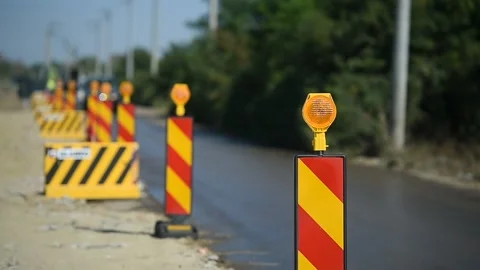 Yellow warning lights in a hazard zone during construction road works 스톡 동영상 137644765