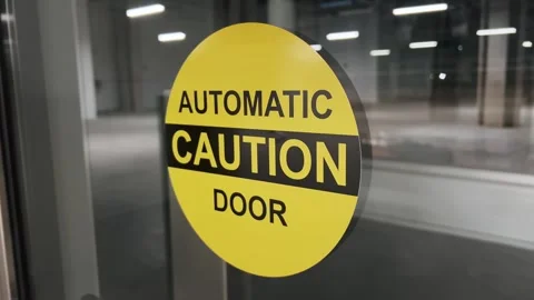 Yellow warning sign on automatic door Stock Footage 316802290