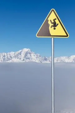 Yellow warning sign of possible fall from a cliff. Dangerous extreme sports c Stock Photos