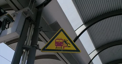 Yellow Warning Sign Under Curved Station Roof, Steel Beam Frame, Wide Shot Stock-Footage 340667355