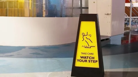 Yellow Watch Your Step Caution Sign on Wet Floor with Copy Space Stock Footage 345831179