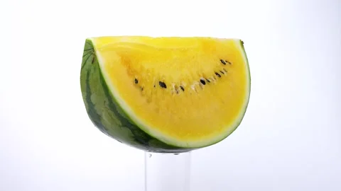 Yellow Watermelon Slice Rotating Against a White Background Vídeos de archivo 337328086