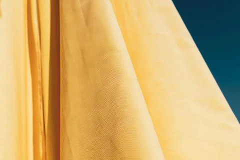 Yellow wavy textile background Stock Photos