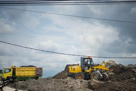 Yellow Wheel Loader and Dump Truck Working Together at Construction Site fo.. Stock Photos