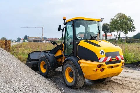 Yellow wheel loader on a construction site. Stock Photos