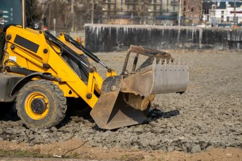 Yellow wheel loader Excavator machine working at construction site with a sand Stock Photos