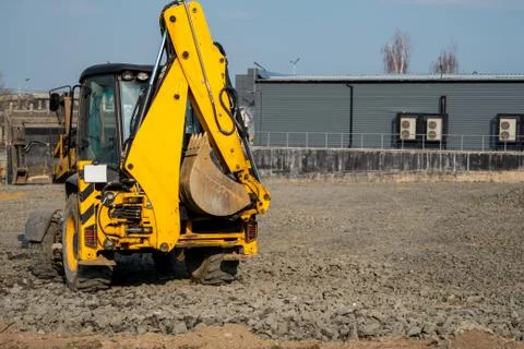 Yellow wheel loader Excavator machine working at construction site with a sand Stock Photos