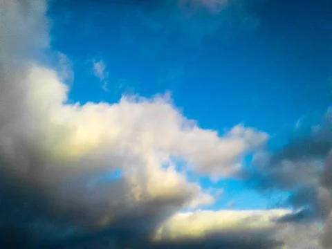 Yellow-white clouds on a blue sky Stock Photos