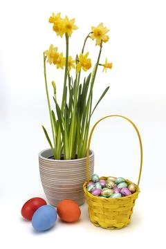 Yellow Wicker Easter Basket with Chocolate and Hand Painted Eggs Stock Photos