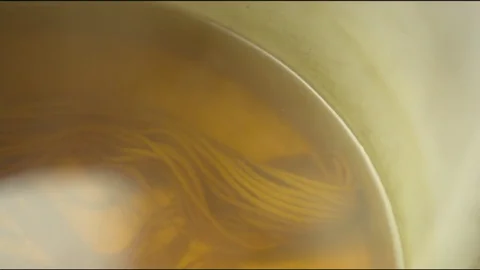 Yellow wool being boiled on pan in kitchen at home Vídeos de archivo 76098048