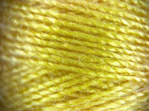 Yellow yarn thread texture close up macro concept for knitting, textile industry 库存照片