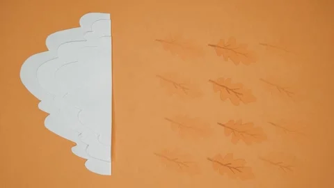Yellowed leaves fall from the cloud instead of raindrops 動画素材 141516753