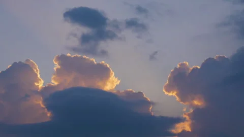 Yellowish, orange and dark colored cloud in a sky in a sunset horizon Stock Footage 258715141