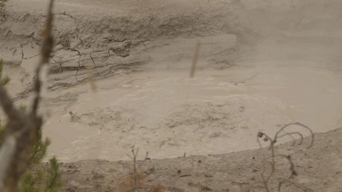 Yellowstone Very Active Pool of Hot Bubbling Boiling Mud Pot Stock Footage 122224356