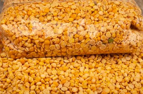 YelloYellow split peas in a plastic bag and cereal in bulk on a background of Stock Photos