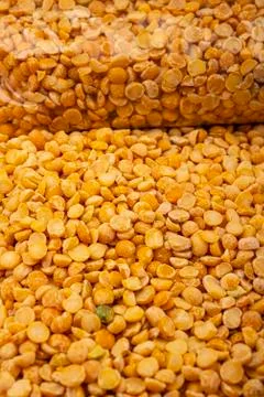 YelloYellow split peas in a plastic bag and cereal in bulk on a background of Stock Photos