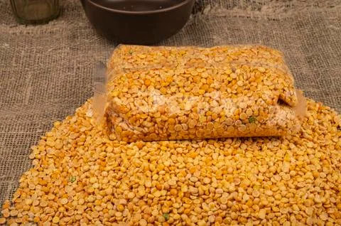 YelloYellow split peas in a plastic bag and cereal in bulk on a background of Stock Photos
