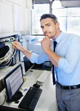 Yep, theres a problem...Portrait of a computer engineer working on a server. Stock Photos