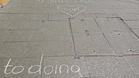YES CAMPAIGNERS WRITE CHALK ON PAVEMENT IN REDFERN REFERENDUM 2023 AUSTRALIA 4K Stock Footage 252951673