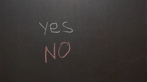 Yes or No on blackboard background. Female hand chooses Yes Stock Footage 127299630