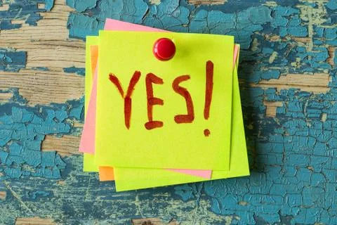 YES text written on sticky note on rustic  background Stock Photos