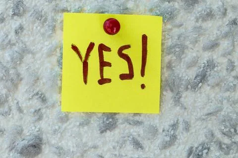 YES  text written on sticky note on gray background Stock Photos