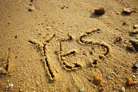 YES words on sand Stock Photos