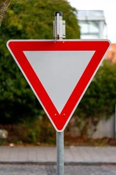 Yield sign giving priority to approaching traffic Stock Photos