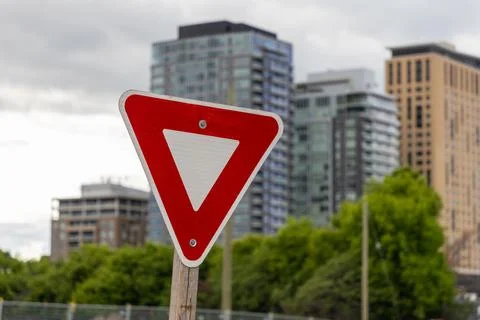 Yield traffic red triangle sign on city street in Ottawa, Canada. Stock Photos