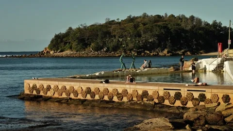 Yoga and exercise next to The Sea Nymphs sculpture pool in Manly slomo Video stock 293241192