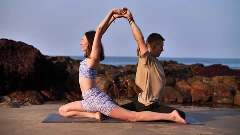 Yoga class in couples on the coast Video stock 263531697