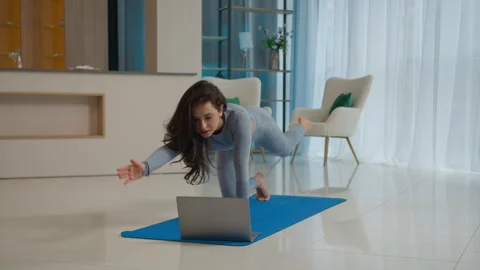 Yoga class with laptop workout video tutorial online training at home fit 스톡 동영상 277174640